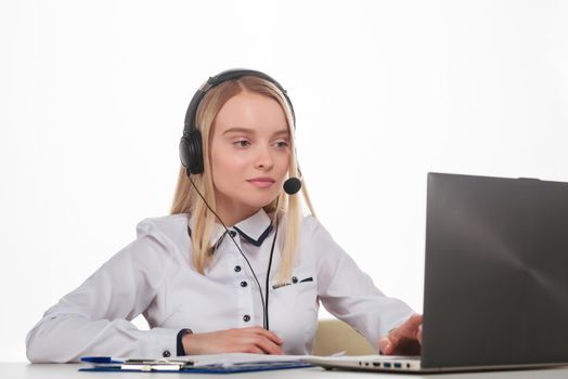 Portrait of happy smiling female customer support phone operator at workplace. - Image