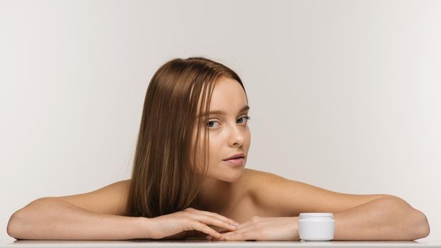 Beautiful spa girl with jar of cream isolated on white background - Image