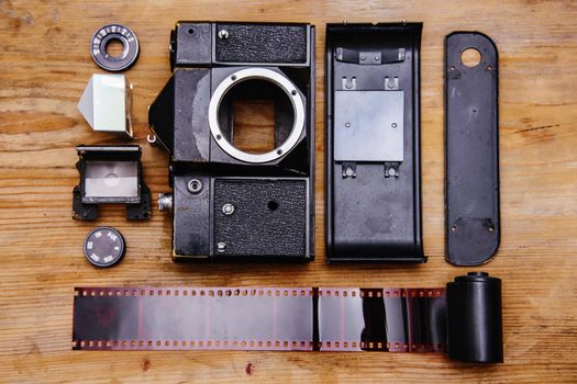Disassembled rangefinder camera. isolated on wooden background.