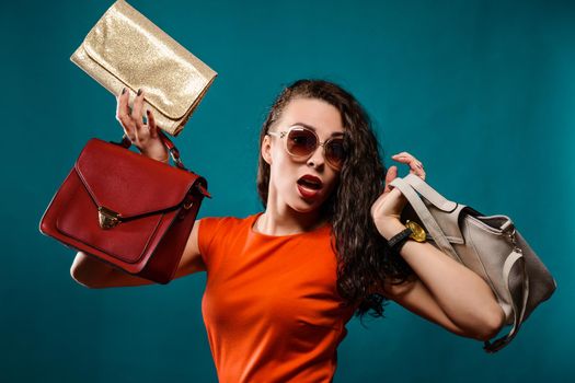 Fashion woman portrait isolated. Happy girl hold bags. Red dress. female beautiful model.