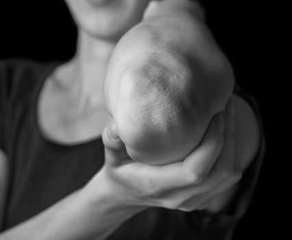 Woman holds her elbow joint, acute pain in the elbow, black and white image