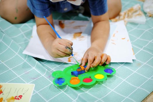 Children use watercolor brushes to create imagination and enhance their learning skills