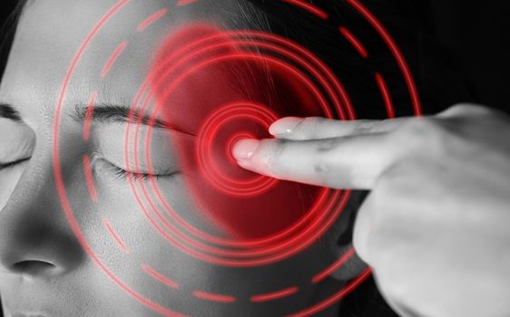 Sad woman touches her head, migraine, pain area of red color
