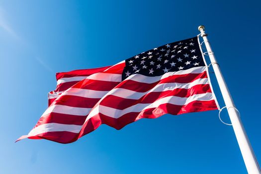 american flag waving in blue sky