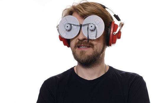 portrait of young man with glasses of tapes listen to music on white background