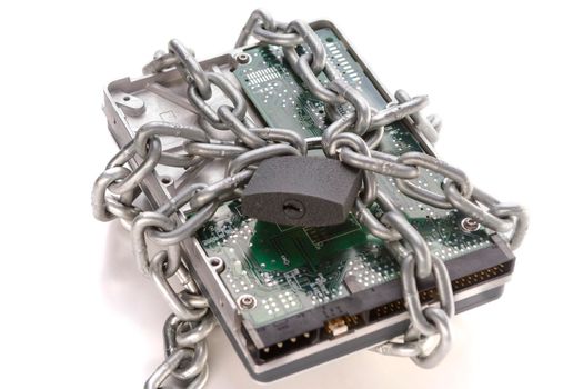 Metal chain and lock around hard disc drive on white. Secure data. Focusing on the center of the chain