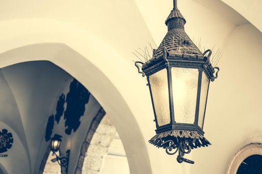 old ceiling lantern in old building with arches