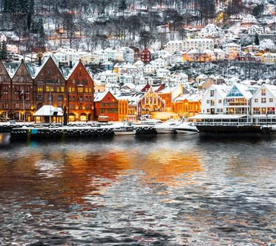Bryggen street with wooden houses with reflection in Bergen at Christmas, Norway
