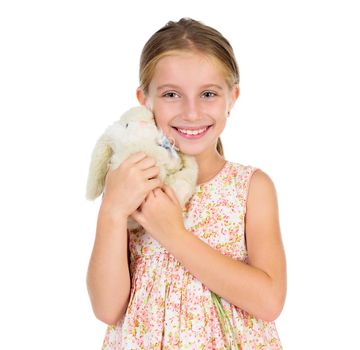 little girl holding toy bunny with her eyes squinted isolated on white background