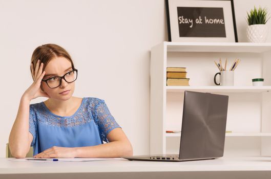 Sad and worried entrepreneur working on line with a laptop in an office desk or home - Image