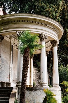 Round marble gazebo with pillars in the garden. Villa Monastero, Como, Italy. High quality photo