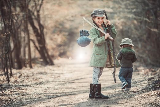 little girl goes through the woods with stuff, photo in vintage stylev