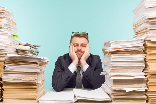 Close-up image of a stressful businessman tired from his work on the foreground - image
