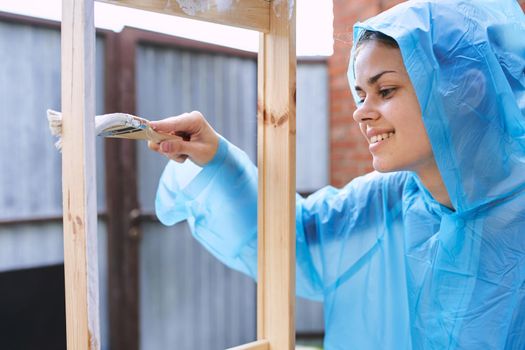 woman house painter renovating wood fittings at home. High quality photo