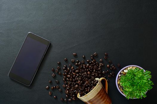  smartphone and coffee beans on the desk, top view
