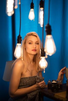 Portrait of a beautiful woman and vintage lamps. Woman looking at the camera - Image