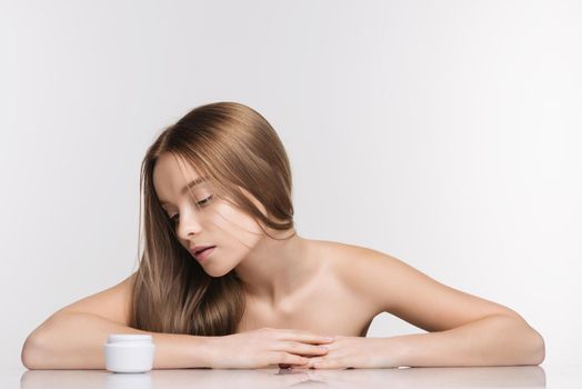 Beautiful spa girl with jar of cream isolated on white background - Image