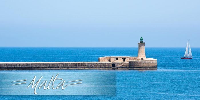 postcard with lighthouse in Valletta port of Malta on misty sea background with a ship