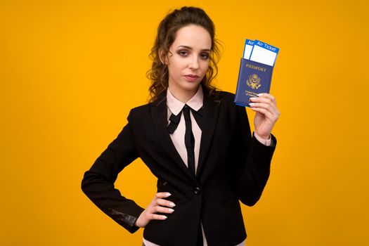 Business Woman Holding Tickets And Passport On Yellow Studio Background - image