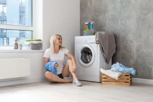 pretty smiling girl in the laundry room
