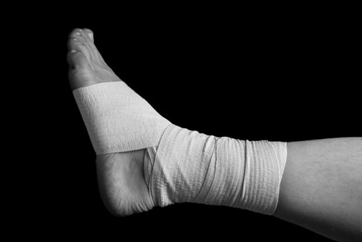 Bandaged leg, foot sprain, monochrome image