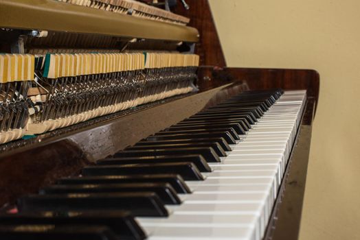 Piano keyboard background with selective focus. Warm color toned image