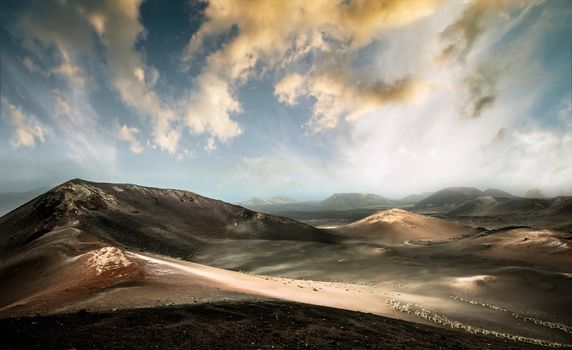 beautiful mountain landscape with volcanoes in Timanfaya National Park at sunset in Lanzarote, Canary Islands