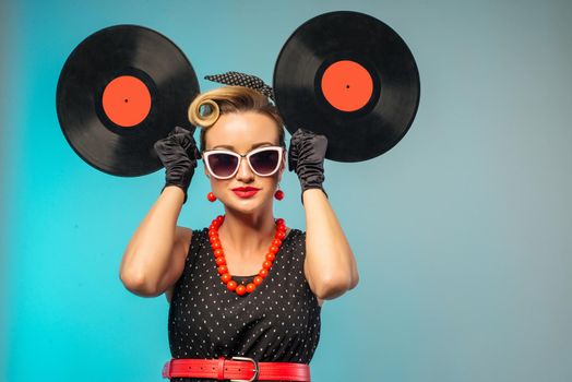 A photo of glamorous pin-up girl holding vinyl LP in hand - image