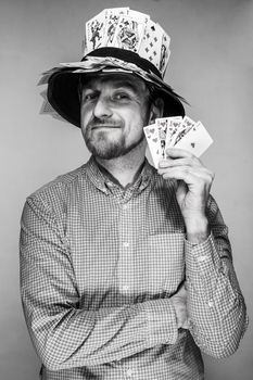 man in the hat of playing cards on gray background