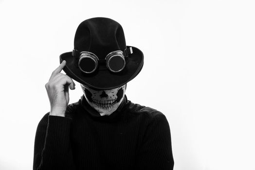 Portrait of a steampunk man in the hat and mask skeleton on white background.