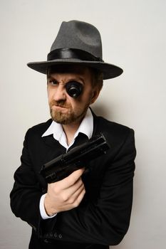 crazy beard detective whit gun in hat at white background