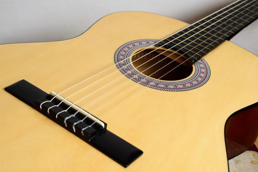 Body classical guitar with yellow deck isolated on white background.