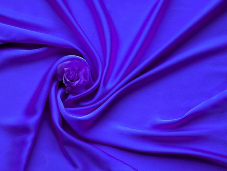 Blue Silk And Rose Petals. rose on a silk abstract. Valentines day copy space for a text. Smooth and elegant satin texture with rose flower. Luxury material waves, wavy pink folds