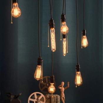 Incandescent bulbs on blue background in loft style.