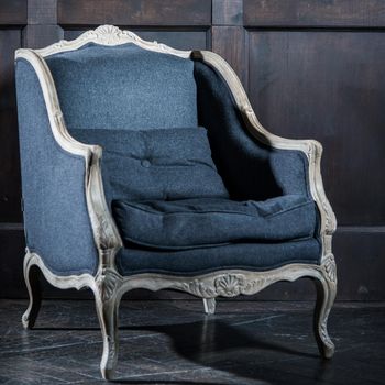 Blue classical style Armchair sofa couch in vintage room.