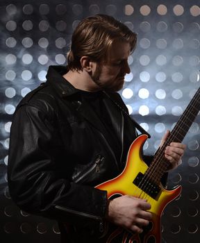 rock guitarist playing electric guitar in fog