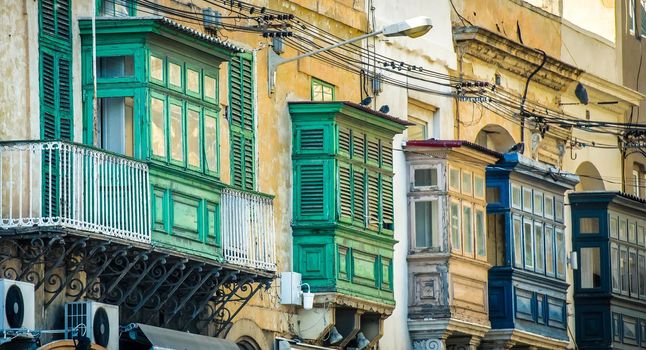 street with traditional balconies in historical center of Valletta in Malta