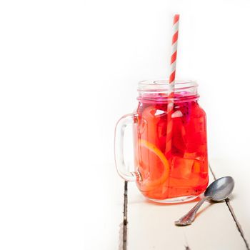 fresh fruit punch refreshing summer  drink over white rustic wood table