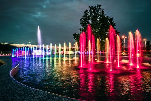 colorful illuminated musical fountain in Warsaw at dusk
