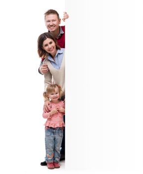 father, mother and little daughter peek out from behind empty blank isolated on white background