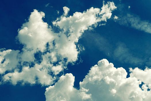 Incredibly wonderful lush cumulus clouds against a blue sky - Image toned