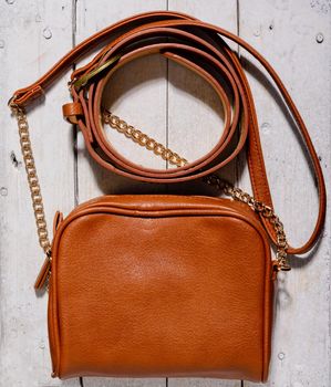 woman bag and belt on wooden background