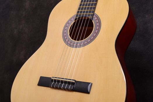 Acoustic classical guitar. Close-up deck and strings.