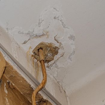 Big wet spots and cracks on the ceiling of the domestic house room after heavy rain and lot of water - Image