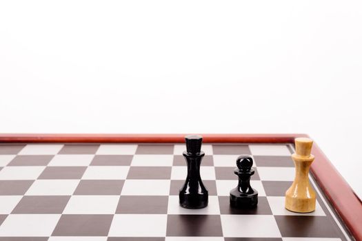 old chessboard and three figures on a white background.