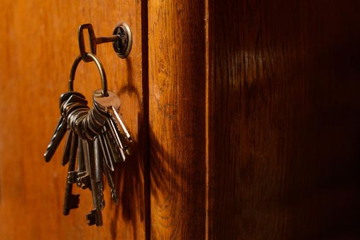 keys in the lock of a old door concept