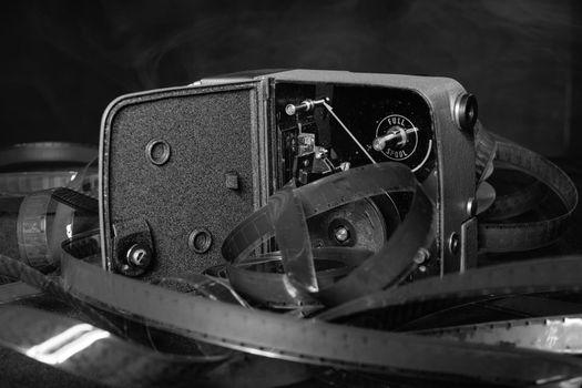 Old movie camera with film reels and on the table.