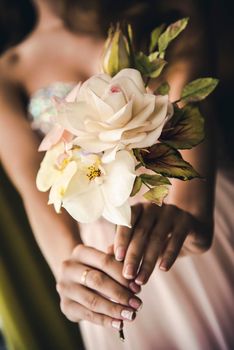 Bride holding wedding flowers bouquet.