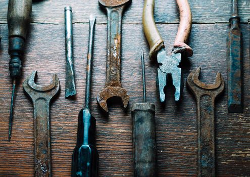 Set of old working tools on wooden table