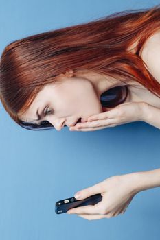 woman with red hair bare shoulders talking on the phone. High quality photo